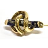 A VICTORIAN YELLOW METAL STICK PIN the top of coiled tubular design around a blue enamel straight