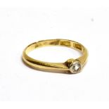 AN 18CT YELLOW GOLD RING with a small diamond approx. 0.10 carat, rub over setting, ring size K,
