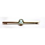 A 9 CARAT GOLD AQUAMARINE SINGLE STONE SET BAR BROOCH the aquamarine approx. 7.5mm x 5.5mm, bar