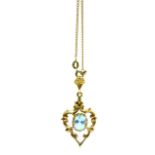 A 9 CARAT GOLD BLUE TOPAZ SET PENDANT AND CHAIN the open scrollwork pendant with oval cut blue topaz