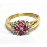 A RUBY AND DIAMOND CLUSTER 9 CARAT GOLD RING oval cluster comprising four rubies and small diamond
