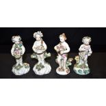 THREE 18TH CENTURY BOW FIGURES OF PUTTI each typically modelled with floral headdresses and