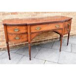 A GEORGE IV MAHOGANY BOWFRONT SIDEBOARD the top with reeded edge, central door flanked by deep