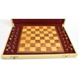 A CASED TRAVELLING SILVER AND SILVER GILT CHESS SET with wooden board. Condition Report : Condition: