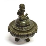 A CARVED SERPENTINE LIDDED BOWL the finial modelled as a cherub, the bowl with three masks and paw