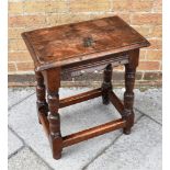 AN OAK JOINT STOOL the rectangular top with moulded edge, 46cm x 28cm, on turned support united by