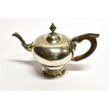 A GEORGIAN SILVER SMALL TEAPOT of plain pear-shaped design, applied scroll decoration to spout,