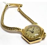 A LADIES 9 CARAT GOLD VINTAGE WRISTWATCH and 9 carat gold bracelet, small round steel dial,