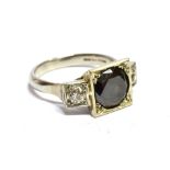 A BLACK AND WHITE DIAMOND, THREE STONE PLATINUM RING the round brilliant cut black diamond, weighing