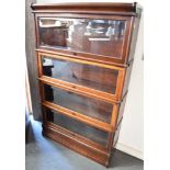 A MAHOGANY GLOBE WERNICKE FOUR TIER SECTIONAL BOOKCASE with bevelled glazed up and over doors, 86.