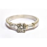 A DIAMOND SOLITAIRE WHITE GOLD RING with diamond set shoulder, the round brilliant cut diamond