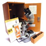 A KYOWA BINOCULAR MICROSCOPE serial no. 791528, with inspection sheet dated 1979, in its fitted