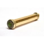 A YELLOW GOLD CASED SMALL RETRACTABLE PENCIL with small green stone and diamond chips to end,