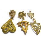 FIVE PAIRS OF VICTORIAN BRASS TRIVETS