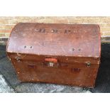 A LEATHER BOUND DOME TOP CANVAS SHIPPING TRUNK initialled 'HMP' to top, 82cm wide 54cm deep 64cm