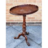 A VICTORIAN MAHOGANY TRIPOD OCCASIONAL TABLE the oval top with shaped gallery, 54cm x 37cm, 74cm