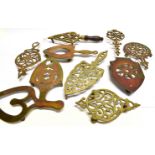 A GROUP OF TEN VARIOUS VICTORIAN BRASS TRIVETS