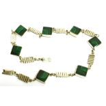A SILVER MALACHITE SET NECKLACE seven offset square cut malachite, groove silver links between each,