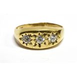A WHITE STONE SET 9 CARAT GOLD RING the boat shaped head gypsy style set containing three round