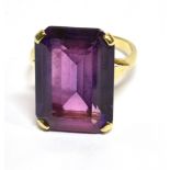 A SYNTHETIC COLOUR CHANGE SAPPHIRE SET 9 CARAT GOLD DRESS RING large rectangular purple/mauve colour