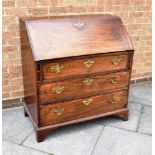 A GEORGE III MAHOGANY BUREAU with fitted interior above three long graduated drawers, 97cm wide 53cm