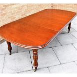 A VICTORIAN MAHOGANY EXTENDING DINING TABLE with two additional leaves, on fluted baluster legs