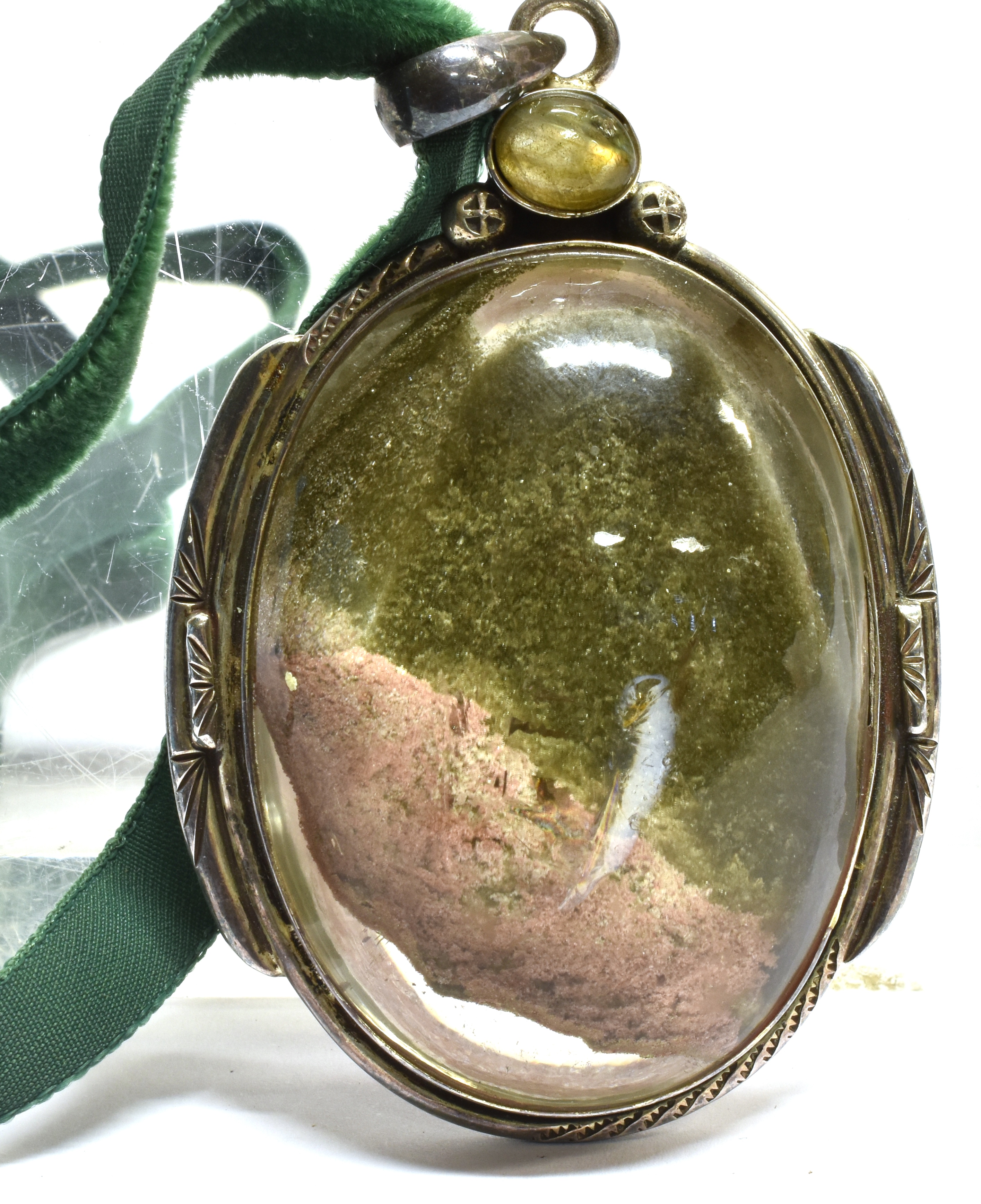 A LARGE OVAL AGATE SILVER PENDANT on a green cord necklace, the agate approx. 55mm x 45mm,