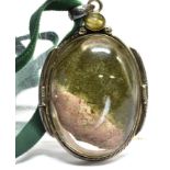 A LARGE OVAL AGATE SILVER PENDANT on a green cord necklace, the agate approx. 55mm x 45mm,