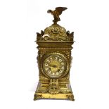 A CONTINENTAL BRASS CASED MANTLE CLOCK with eagle surmount, the 8-day movement striking on a
