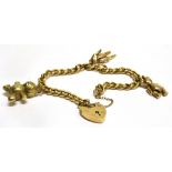A 9 CARAT GOLD CHARM BRACELET with three 9 carat gold teddy bears and a padlock fastener complete