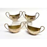 A SET OF FOUR SMALL SILVER SALTS of oval two handled form, half fluted by James Dixon & Sons 1909,