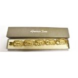 A 14 CARAT YELLOW GOLD SAFARI BRACELET comprising 5 openwork panels set with a leopard, elephant,