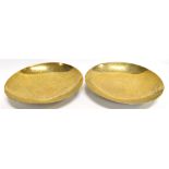 A PAIR OF CHINESE BRASS DISHES, chased decoration of celestial dragons and Chinese characters,