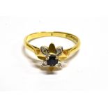 A SAPPHIRE AND DIAMOND FLOWER HEAD CLUSTER 18 CARAT GOLD RING small round sapphire with four small