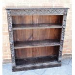 A CARVED OAK OPEN BOOCKASE with three adjustable shelves, 105cm wide 31cm deep 122cm high