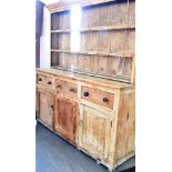 A VICTORIAN PITCH PINE DRESSER the base fitted with three drawers above cupboards, 184cm wide 51cm