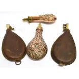 FOUR ASSORTED POWDER FLASKS two copper and two leather, all with brass mounts, the largest 24cm