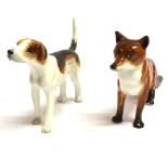 A ROYAL CROWN DERBY FIGURE OF A STANDING FOX height 9cm; and another of a standing hound, height 9cm