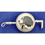 A WHITE METAL BROOCH/STOCK PIN in the form of a crop centred with the head of a collie dog, 7cm