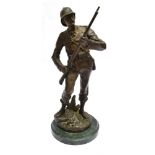 A BRONZE FIGURE OF A STANDING GENTLEMAN in military uniform holding a rifle, with engraved plaque '