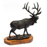 A HEAVY CAST FIGURES OF A STANDING STAG on a shaped wooden base, 47cm high, 46cm wide