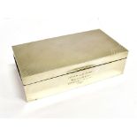 AN ART DECO SILVER RECTANGULAR CIGARETTE BOX with engine turned cover and inscribed '1st Prize