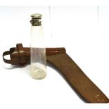 A TAPERED GLASS FLASK with star-cut base and plated mount with leather holder for saddle mounting by