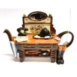 A NOVELTY HUNTING TEAPOT in the form of a dresser, decorated with hunting boots, rosette and hunt