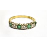 AN EMERALD AND DIAMOND HALF ETERNITY SEVEN STONE 18 CARAT GOLD RING three round brilliant cut