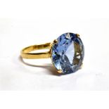 A 9CT GOLD SYNTHETIC BLUE SPINEL SINGLE STONE DRESS RING the large light blue synthetic spinel