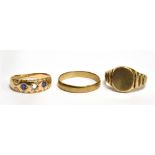 THREE GOLD RINGS comprising a 9 carat gold plain wedding band, a 9 carat gold signet ring,