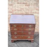 A GEORGE III PROVINICIAL OAK BUREAU with fitted interior above four long graduated drawers, on