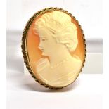 A 9 CARAT GOLD OVAL CAMEO BROOCH Carved shell cameo with a head and shoulders profile of a young