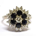 A DIAMOND AND SAPPHIRE THREE TIER CLUSTER 18 CARAT WHTE GOLD RING the central round brilliant cut